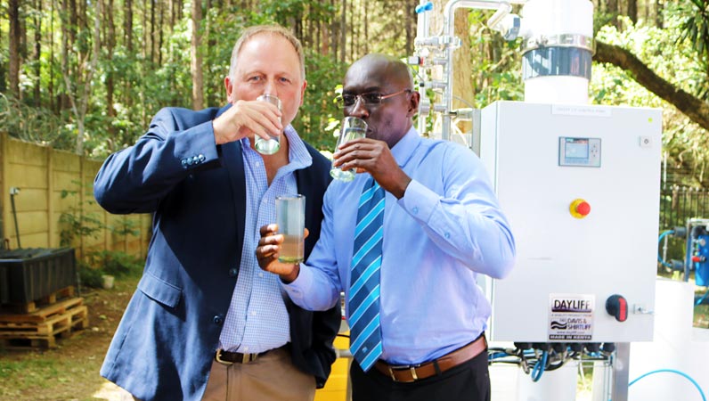 David Gatende having clean Water for drinking from Dayliff DOW Ultrafiltration Event