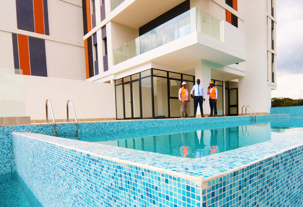 Sales Engineer Evanse Ongoro handing handing over a project after supplying various pool pumps and equipments to riverbank apartments a flagship proect by centum Real estate